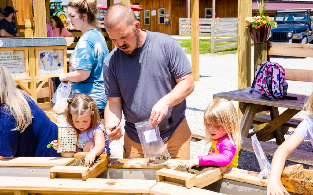family sifting for gems at the mining sluice